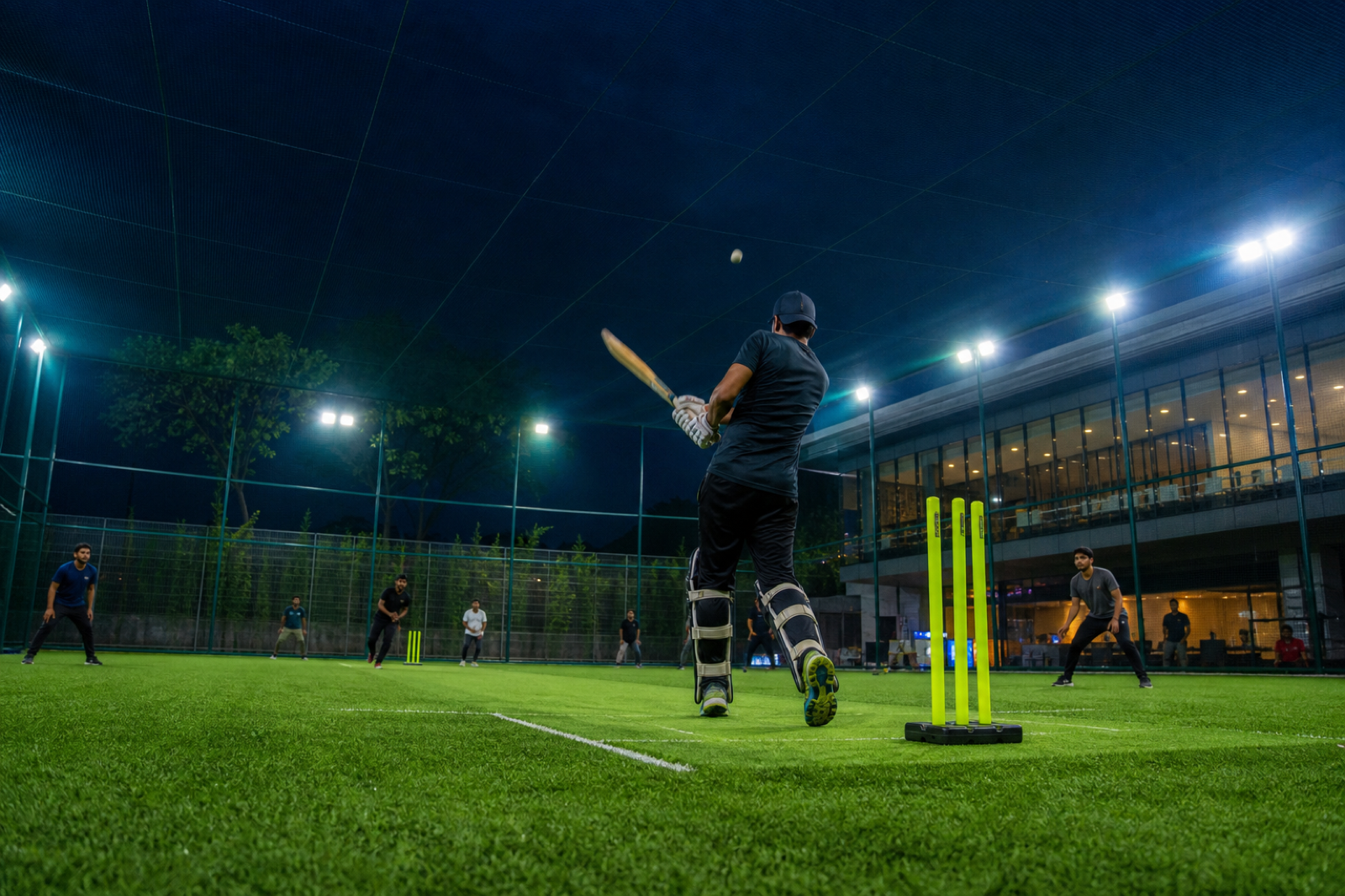 A cricket batter playing under the turf floodlights